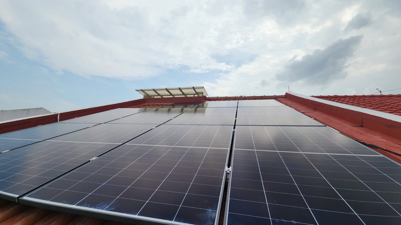 Solar panels mounted on a clay-tiled roof at Watten Estate, Lorong Marican